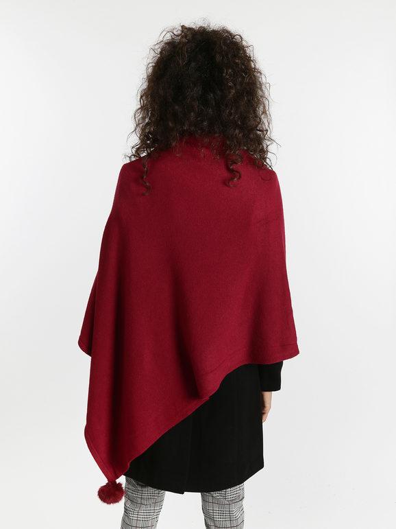 Knitted poncho with pompom
