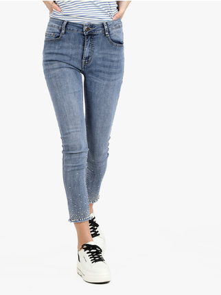 Women's jeans with rhinestones and pearls on the hem